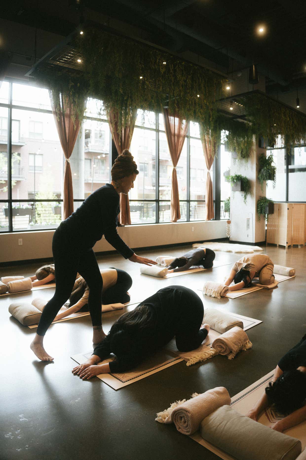 A teacher guides a movement class in the Sun Studio at Sacred Society