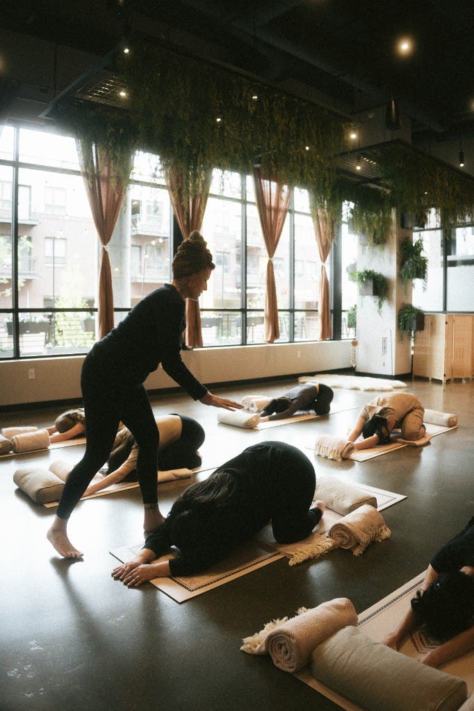 The Sun Studio during a movement class, an open bright room with mats in rows